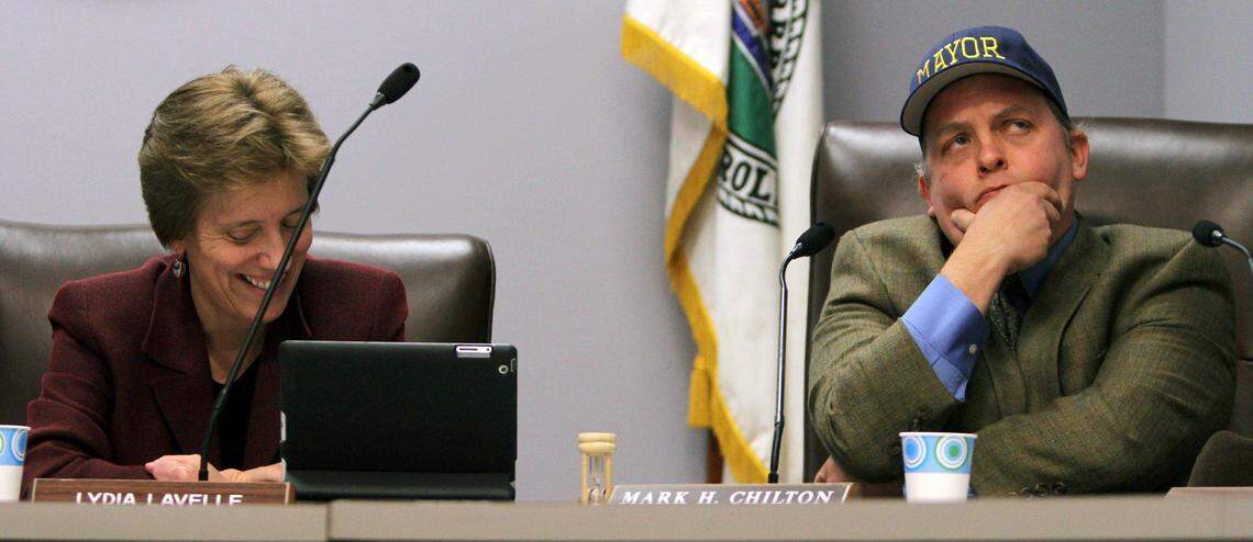 Carrboro Mayor Lydia Lavelle and former Mayor Mark Chilton share a light-hearted moment during Lavelle’s swearing-in ceremony at Carrboro Town Hall in 2013.
