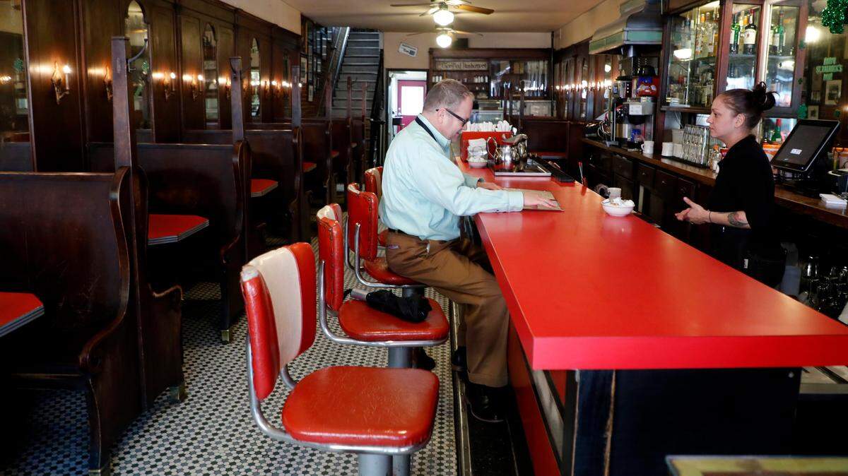 Carla Edge takes the lunch order of Luther Snyder of Cary at Mecca Restaurant in Raleigh in Raleigh, N.C., Tuesday, March 17, 2020. Gov. Roy Cooper ordered bars and restaurants to close at 5 p.m. Tuesday, except for take-out and delivery. Mecca Restaurant will offer curbside pickup and delivery via DoorDash.