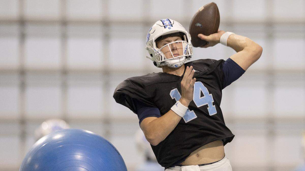 North Carolina graduate transfer quarterback Max Johnson (14) runs through a drill during the Tar Heels’ practice on Thursday, April 11, 2024 in Chapel Hill, N.C.