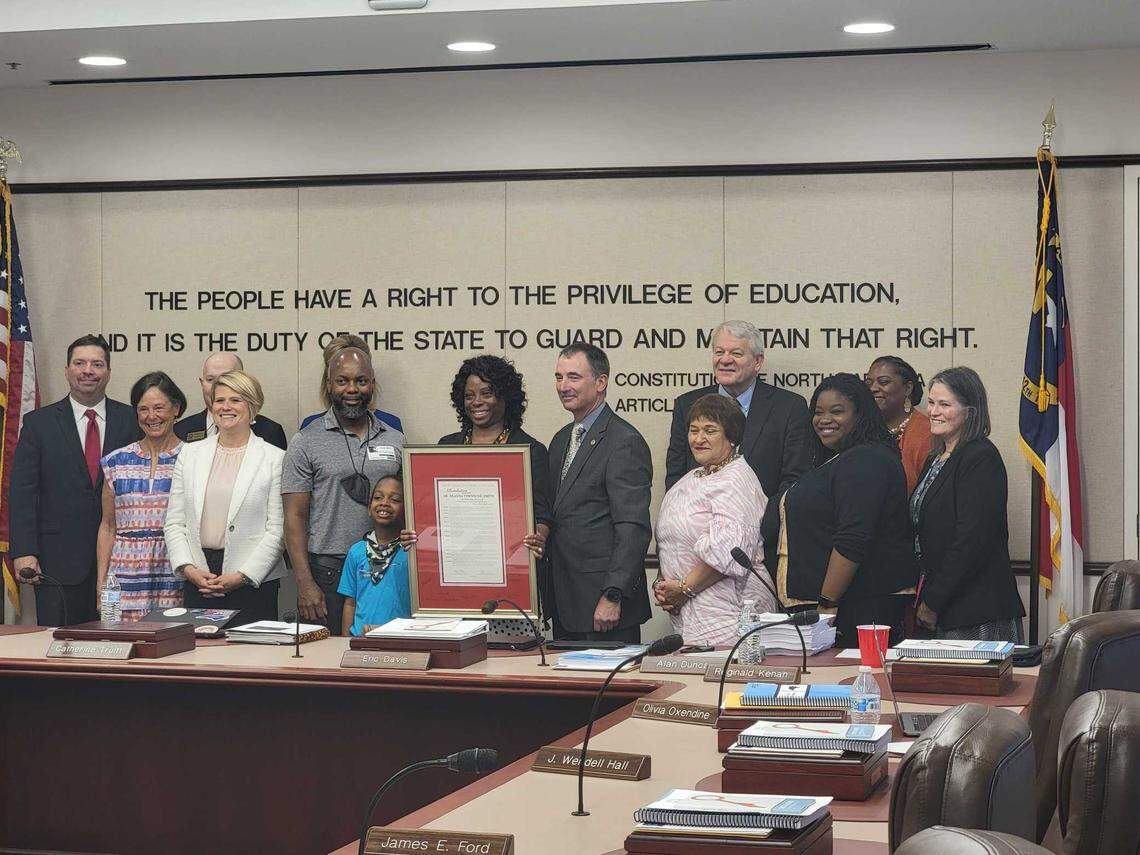 State Board of Education members pose for a group photo in June 2022 with Deanna Townsend-Smith, who left her position as the director of board policy and operations, to become senior director of the Dudley Flood Center for Educational Equity and Opportunity at the Public School Forum of North Carolina.