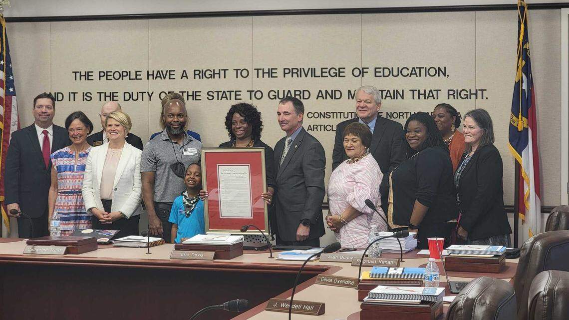 State Board of Education members pose for a group photo in June 2022 with Deanna Townsend-Smith, who left her position as the director of board policy and operations, to become senior director of the Dudley Flood Center for Educational Equity and Opportunity at the Public School Forum of North Carolina.