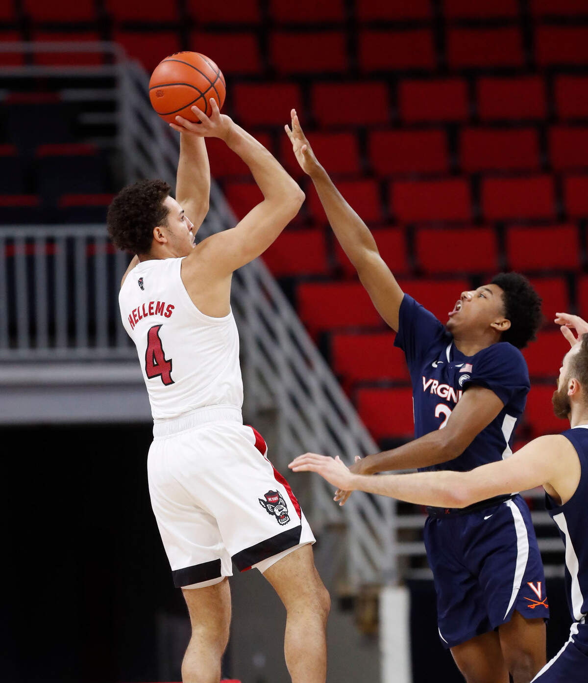 N.C. State’s Jericole Hellems (4) shoots as Virginia’s Reece Beekman (2) defends during the first half of N.C. State’s game against Virginia at PNC Arena in Raleigh, N.C., Wednesday, February 3, 2021.