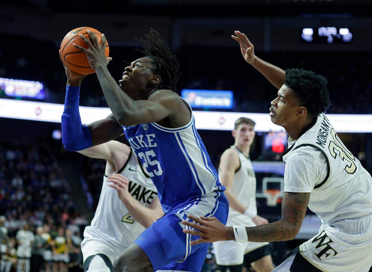 Duke’s Mark Mitchell drives past Wake Forest’s Cameron Hildreth and Damari Monsanto during the second half of a men’s basketball game on Tuesday, Dec. 20, 2022, at Lawrence Joel Veterans Memorial Coliseum in Winston-Salem, N.C.