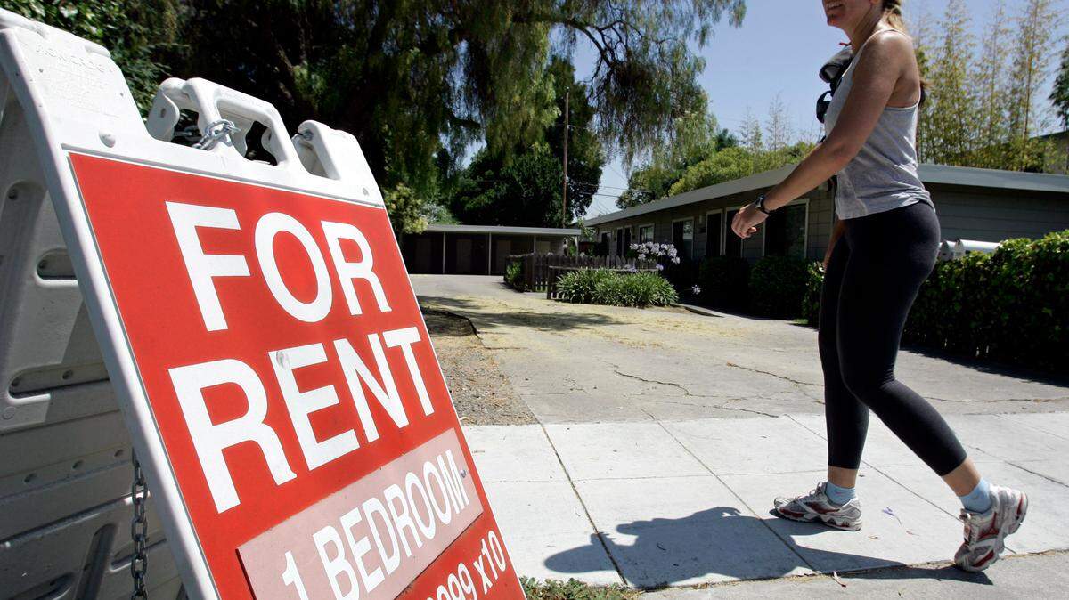 FILE - In this July 19, 2006 file photo, a woman walks next to a “For Rent” sign at an apartment complex in Palo Alto, Calif. Many tenants aren’t familiar with the ins and outs of their renters insurance policies, but what they don’t know could cost them money (AP Photo/Paul Sakuma, File)