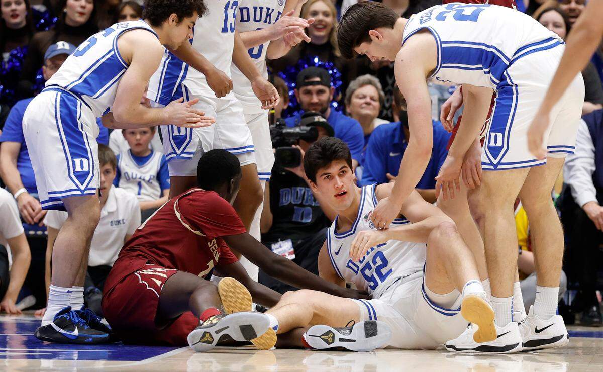 Duke’s Stanley Borden (52) is helped up after diving after a loose ball late in the second half of Duke’s 100-65 victory over Florida State at Cameron Indoor Stadium in Durham, N.C., Saturday, March 1, 2025.