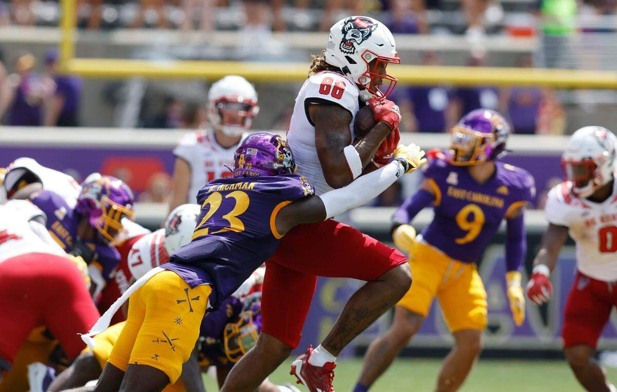 N.C. State wide receiver Devin Carter (88) makes the reception as East Carolina cornerback Damel Hickman (23) defends during the first half of N.C. States game against ECU at Dowdy-Ficklen Stadium in Greenville, N.C., Saturday, Sept. 3, 2022.