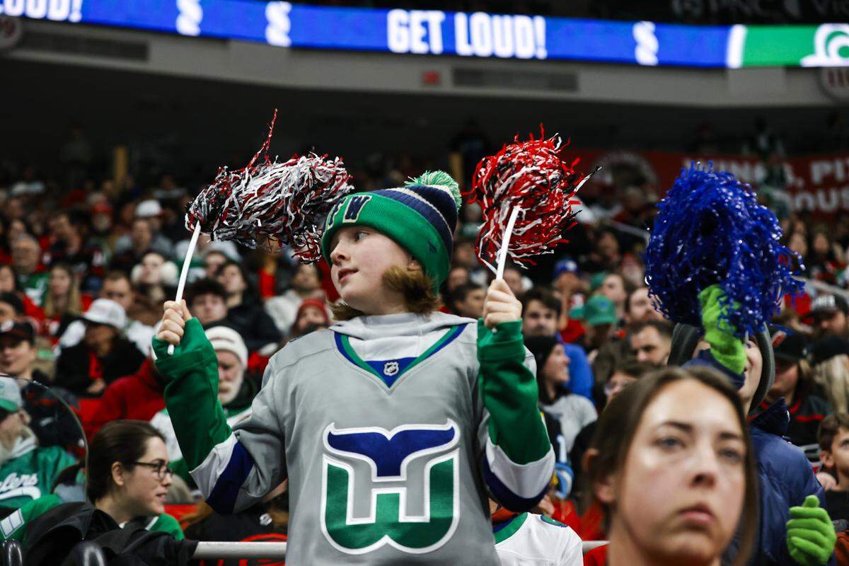 A Carolina Hurricanes fan celebrates during the second period of the game against the Utah Mammoth at Lenovo Center on Jan. 29, 2026 in Raleigh, North Carolina.