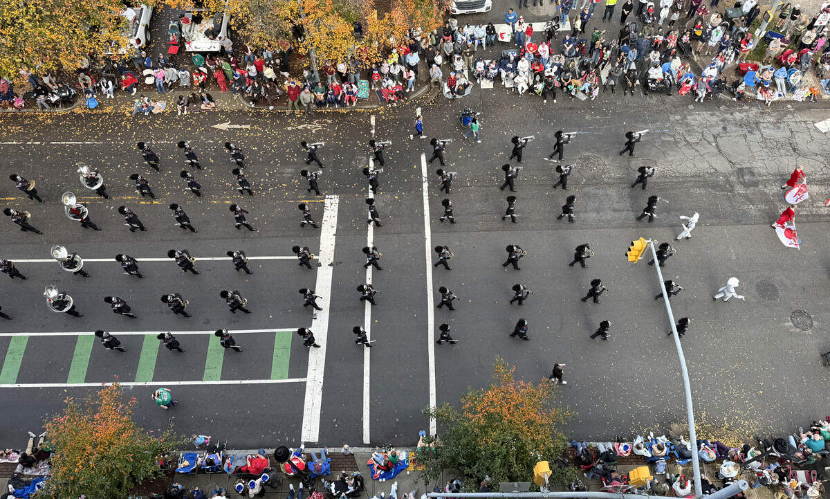 Participants in the Raleigh Christmas Parade march down Hillsborough Street in Raleigh, N.C. Saturday morning, Nov. 22, 2025.