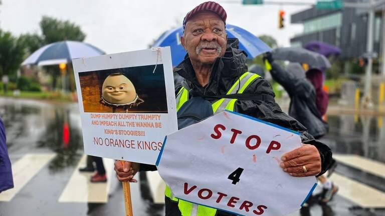 Despite rain, No Kings protesters march to early voting sites across NC