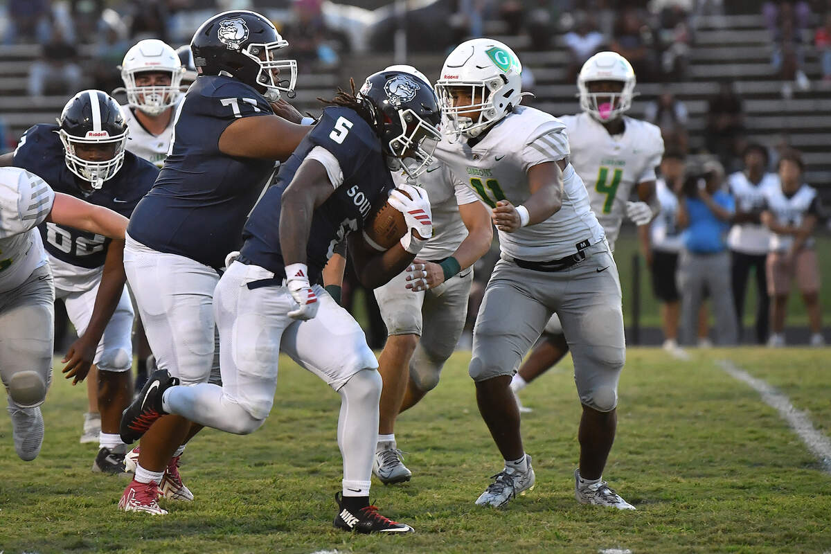 Southeast Raleigh running back Christian Freeman (5) runs for yardage against Cardinal Gibbons during the first half. The Southeast Raleigh Bulldogs and the Cardinal Gibbons Crusaders met in a non-conference football game in Raleigh, N.C. September 12, 2025