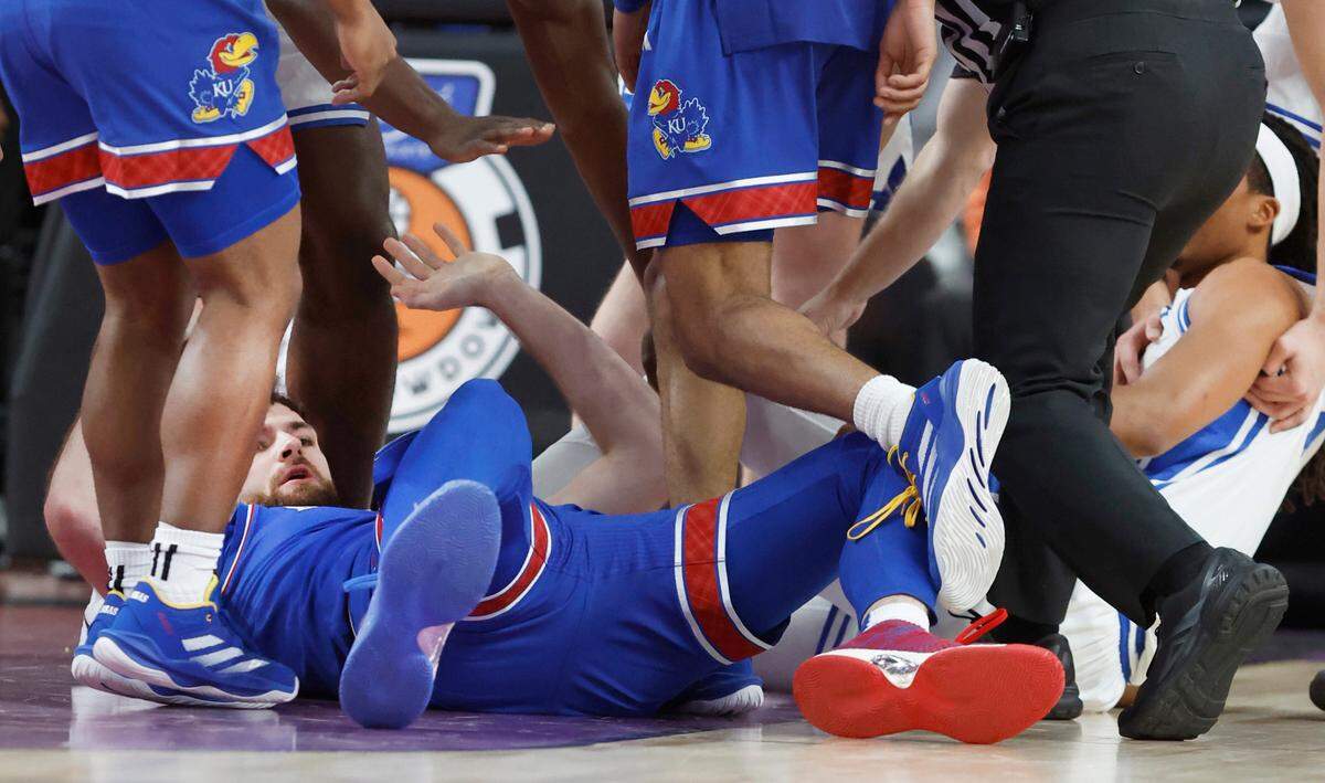 Duke’s Maliq Brown (6), right, is pulled away after being kicked by Kansas’ Hunter Dickinson (1) during Kansas’ 75-72 victory over Duke in the Vegas Showdown at T-Mobile Arena in Las Vegas, Nev., Tuesday, Nov. 26, 2024. Dickinson was ejected on the play.