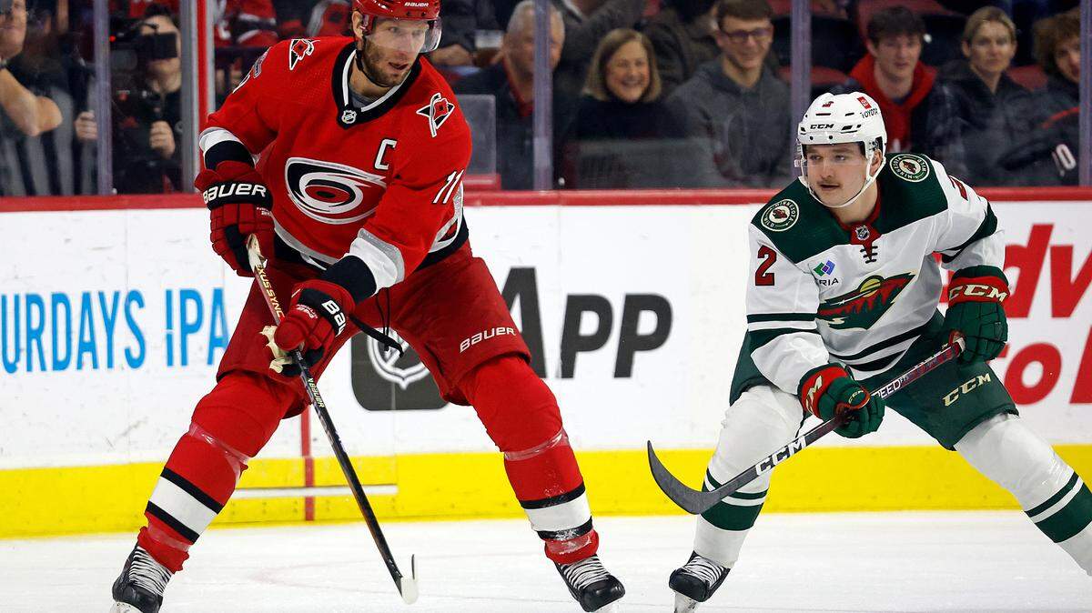 Carolina Hurricanes’ Jordan Staal (11) controls the puck with Minnesota Wild’s Calen Addison (2) nearby during the first period of an NHL hockey game in Raleigh, N.C., Thursday, Jan. 19, 2023. (AP Photo/Karl B DeBlaker)