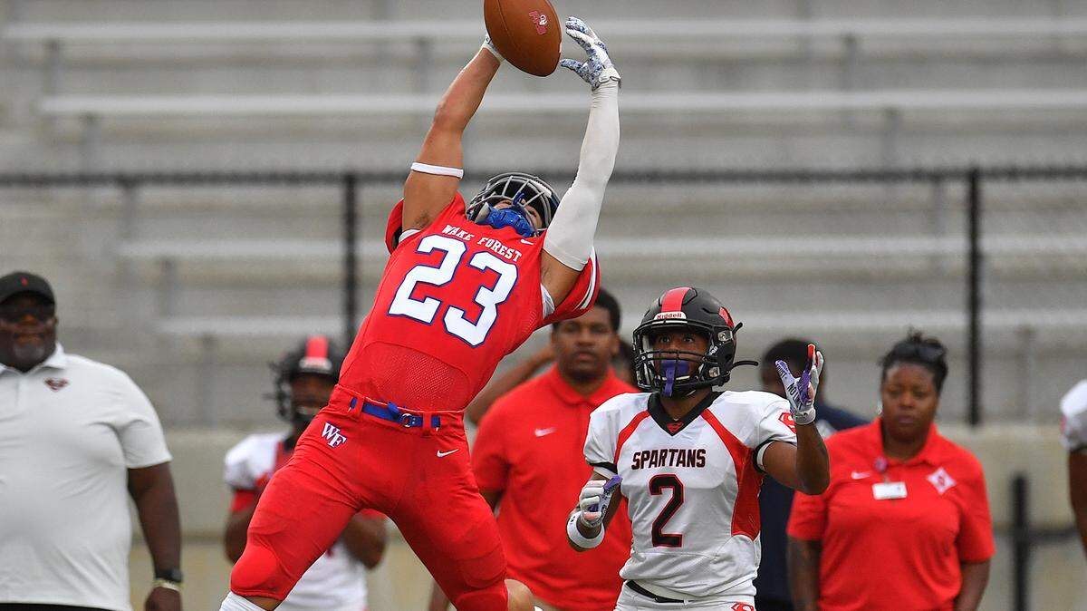 Wake Forest’s Gabe Hollingsworth (23) attempts the interception against Southern Durham’s Justin Baskerville during the first half. The Wake Forest Cougars and the Southern Durham Spartans met in a football game in Wake Forest, N.C. on August 19, 2022.