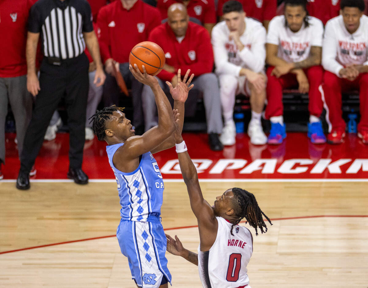 North Carolina’s Harrison Ingram (55) puts up a shot against N.C. State’s D.J. Horne (0) in the first half on Wednesday, January 10, 2024 at PNC Arena in Raleigh, N.C.