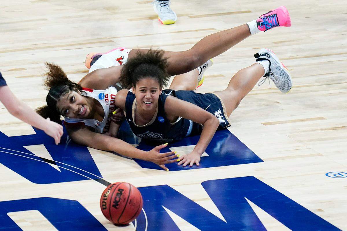 Maryland forward Angel Reese, left, fights for a loose ball with Mount St. Mary’s guard Jada Lee, right, during the second half of a college basketball game in the first round of the women’s NCAA tournament at the Alamodome in San Antonio, Monday, March 22, 2021. Maryland won 98-45. 