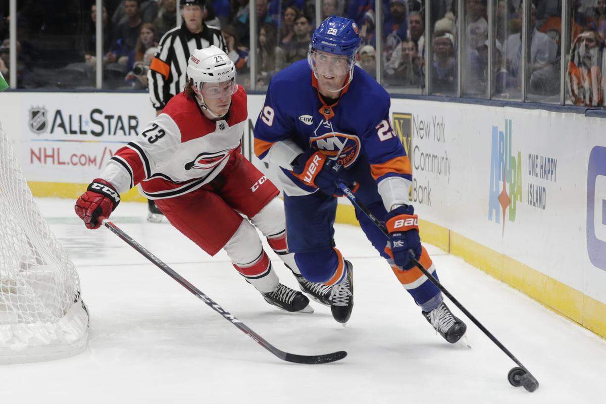 New York Islanders’ Brock Nelson (29) looks to pass away from Carolina Hurricanes’ Brock McGinn (23) during the second period of an NHL hockey game Tuesday, Jan. 8, 2019, in New York. (AP Photo/Frank Franklin II)