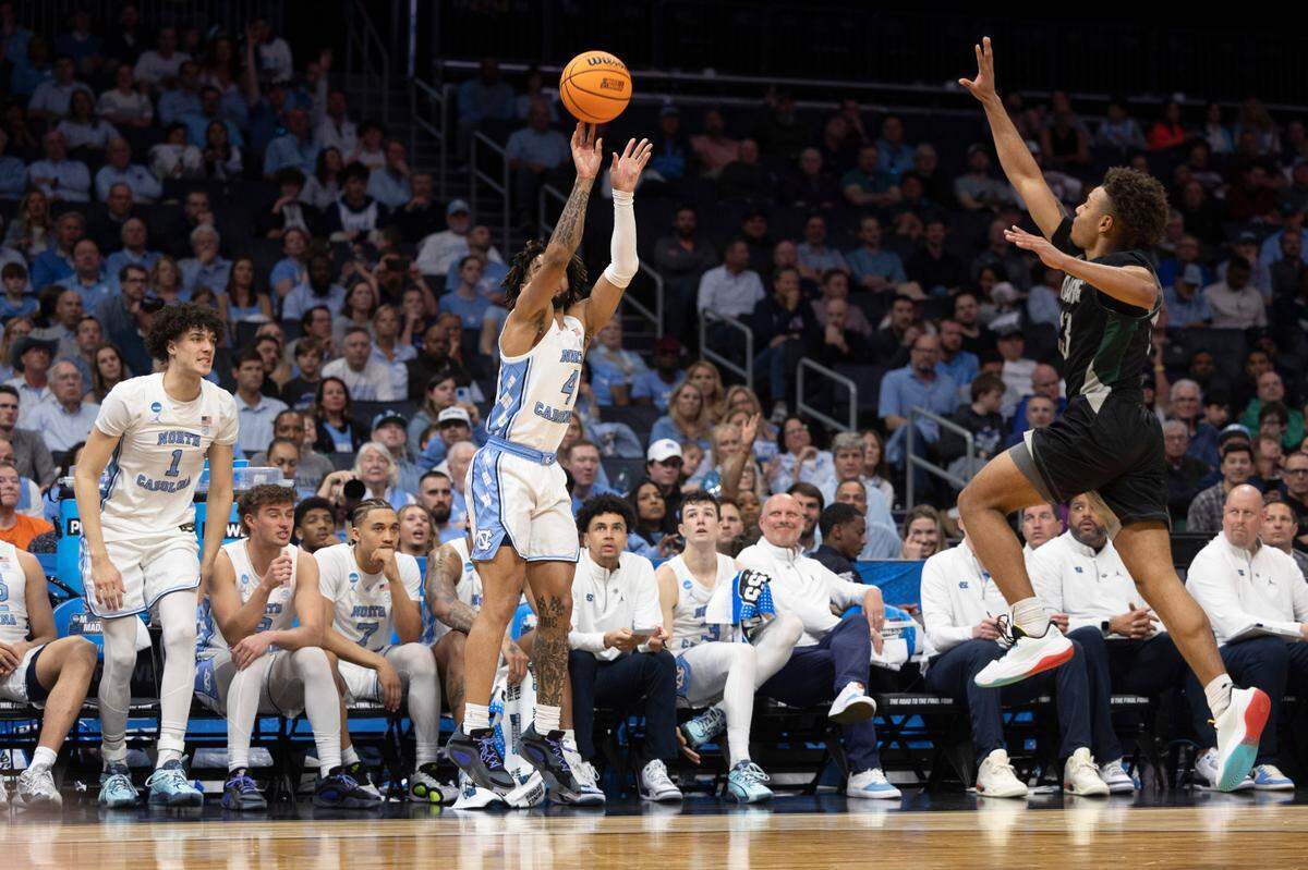 North Carolina’s R.J. Davis (4) launches a three point attempt in the second half against Wagner’s Julian Brown (13) on Thursday, March 21, 2024 during the NCAA Tournament at Spectrum Center in Charlotte, N.C.
