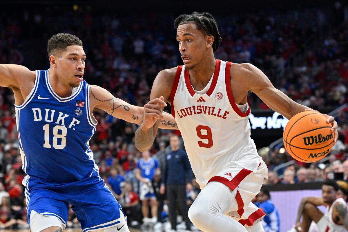 Louisville Cardinals forward Khani Rooths (9) dribbles against Duke Blue Devils forward Mason Gillis (18) during the second half at KFC Yum! Center on Dec. 8, 2024. Duke defeated Louisville, 76-65.