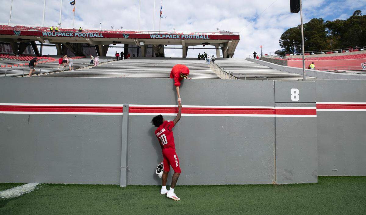 N.C. State wide receiver KC Concepcion (10) greets a fan after N.C. State’s 59-28 victory over Stanford at Carter-Finley Stadium in Raleigh, N.C., Saturday, Nov. 2, 2024.