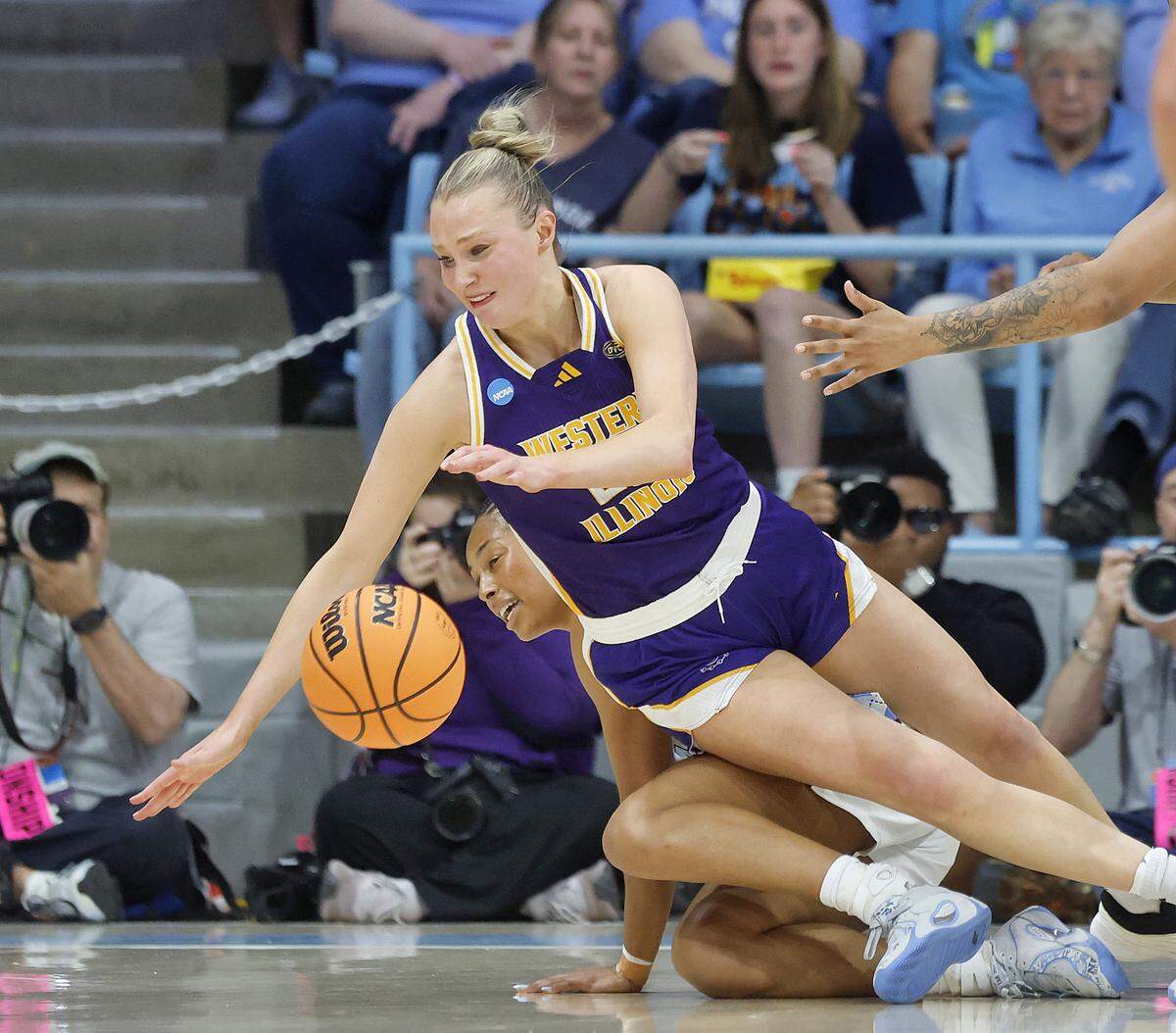 North Carolina’s Indya Nivar and Western Illinois’ Mia Nicastro fall to the court during the first half of the Tar Heels’ 82-51 first-round NCAA Tournament win on Friday, March 20, 2026, at Carmichael Arena in Chapel Hill, N.C.