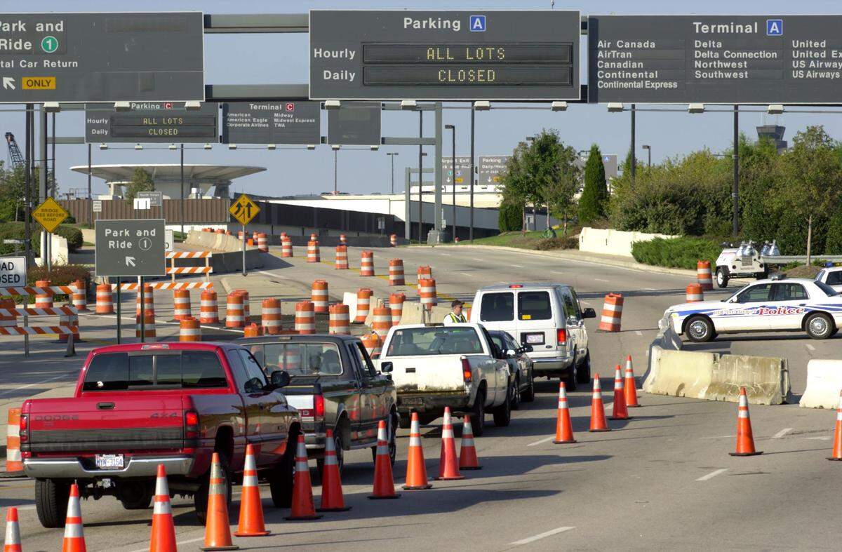 Police check identification at the entrance to RDU International Airport late Tuesday afternoon Sept. 11, 2001, after the terminals were closed, and traffic was funneled to one lane.