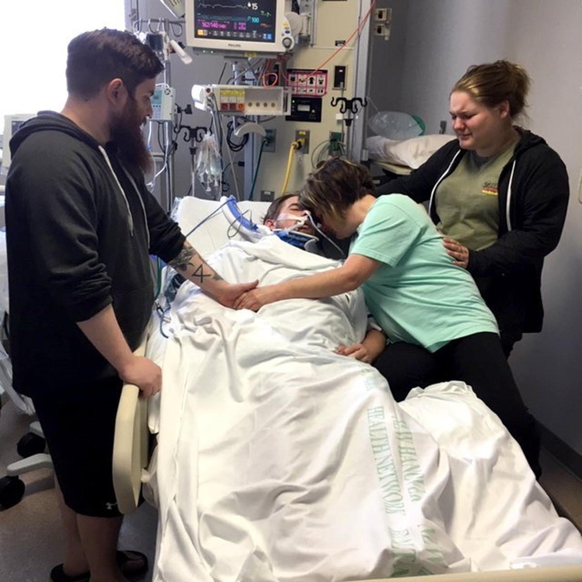 Cindy Patane leans over her son Matt Eyster, who died of an opioid overdose in 2016.