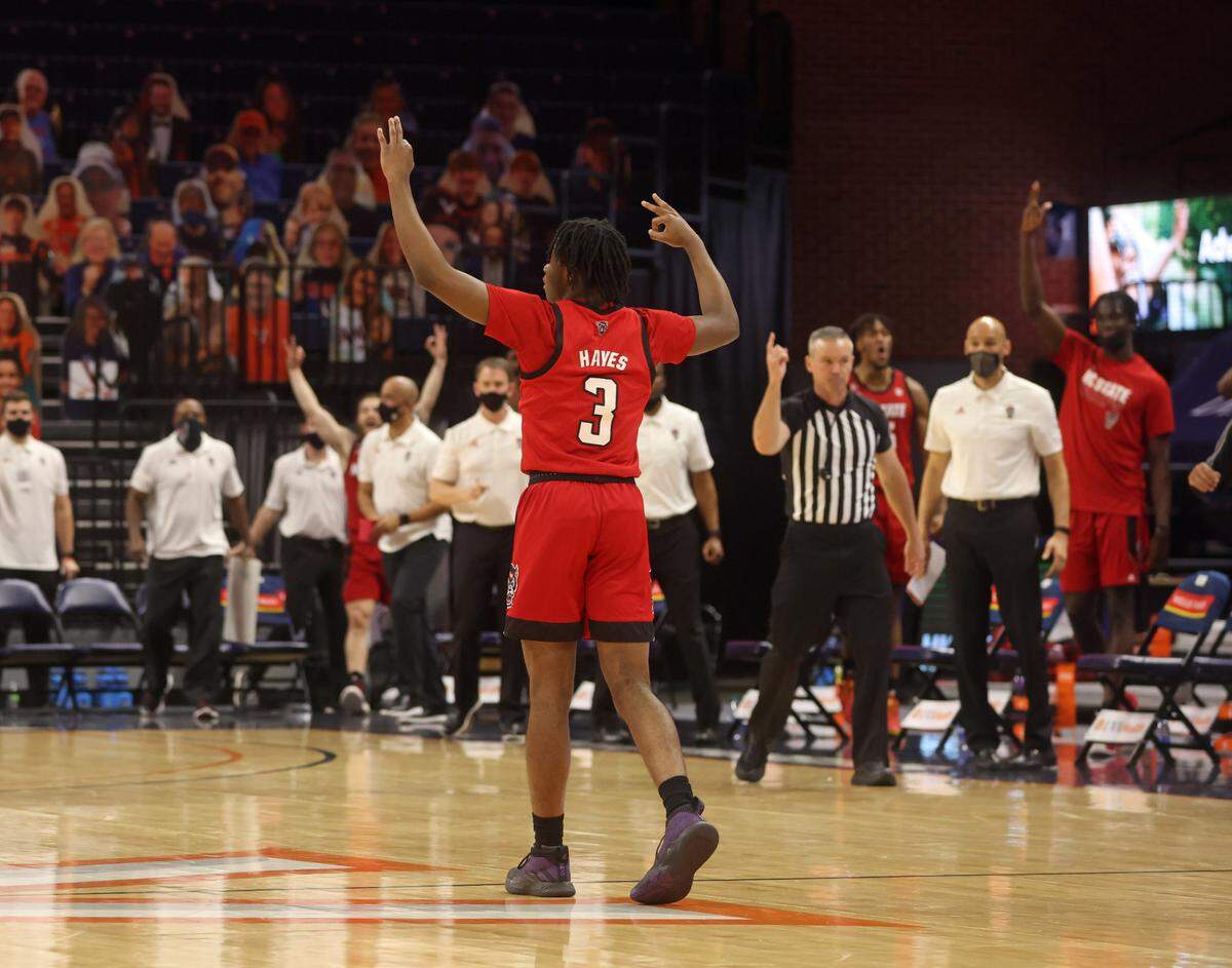 North Carolina State guard Cam Hayes (3) celebrates a 3-point basket during the game Wednesday in Charlottesville, Va. North Carolina State defeated Virginia 68-61.