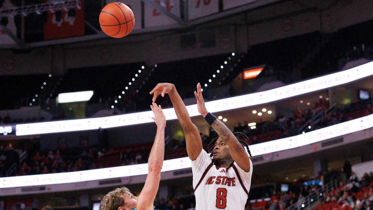 N.C. State’s Jayden Taylor shoots over Coastal Carolina’s Henry Abraham during the second half of the Wolfpack’s 82-70 win on Wednesday, Nov. 13, 2024, at Lenovo Center in Raleigh, N.C.