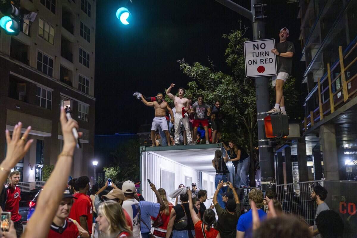 Carolina Hurricanes fans celebrate the team's Stanley Cup victory over the Vegas Golden Knights in Las Vegas in Raleigh's Glenwood South district on Sunday, June 14, 2026. The Hurricanes last won the Stanley Cup in 2006.