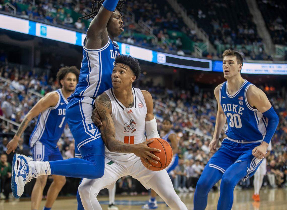 Duke’s Mark Mitchell (25) defends Miami’s Jordan Miller (11) in the second half during in the semi-finals of the ACC Tournament on Friday, March 10, 2023 at the Greensboro Coliseum in Greensboro, N.C.