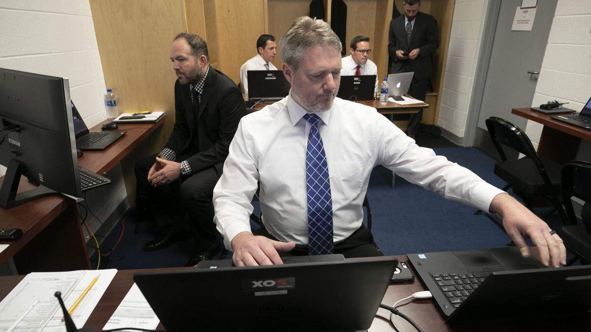Carolina Hurricanes' video coach Chris Huffine sets up two laptops with video feeds to capture game action on April 20, 2018 at Capital One Arena in Washington, D.C. 