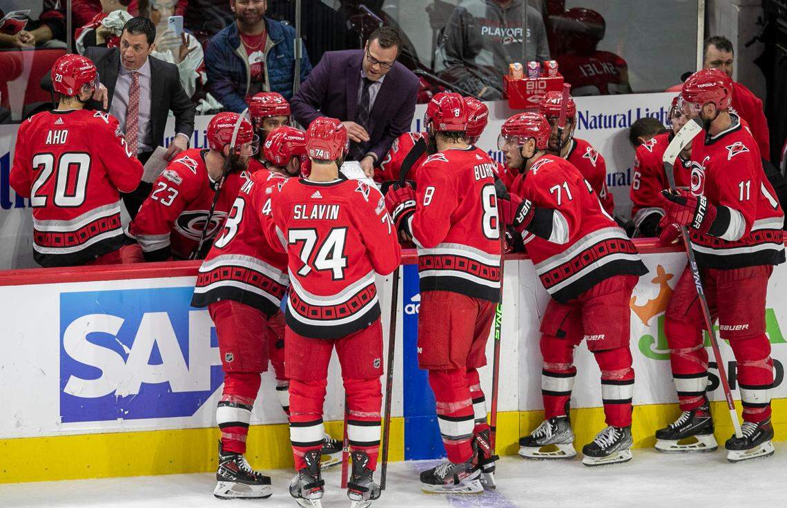 Carolina Hurricanes coach Rod Birnd’Amour works with Sebastian Aho (20) as assistant coach Tim Gleason diagrams a play with Jordan Martinook (48), Jaccob Slavin (74), Brent Burns (8) and Jesper Fast (71) in the third period against the New Jersey Devils during Game 1 of their second round Stanley Cup playoff series on Wednesday, May 3, 2023 at PNC Arena in Raleigh, N.C.
