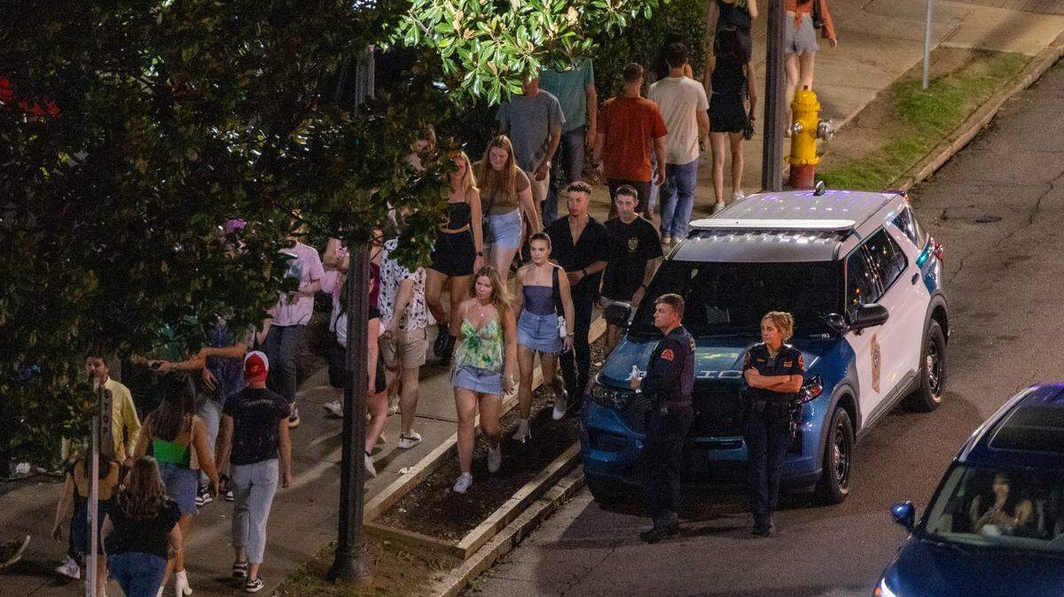 Raleigh police officers maintain a presence at around 1 a.m. in the Glenwood South district on July 21, 2023. A new unit in the department will focus on impaired drivers.