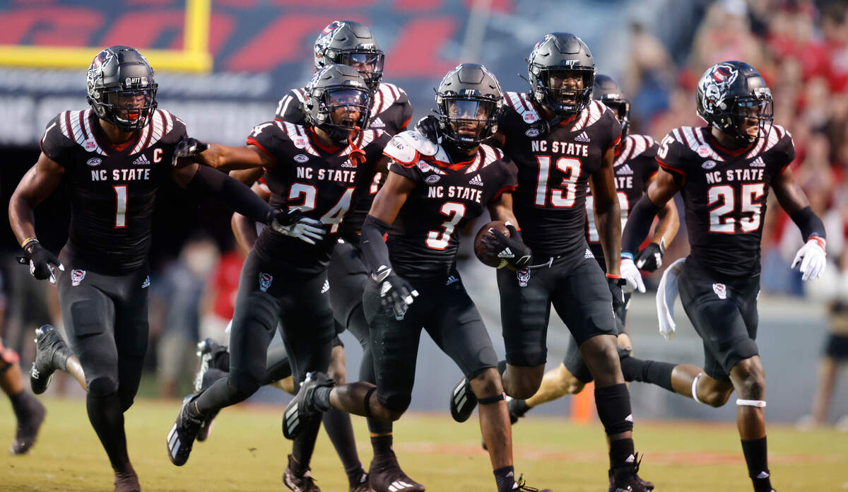 The N.C. State defense celebrates with cornerback Aydan White (3) after White intercepted the ball during the first half of N.C. State’s game against Louisiana Tech at Carter-Finley Stadium in Raleigh, N.C., Saturday, October 2, 2021.