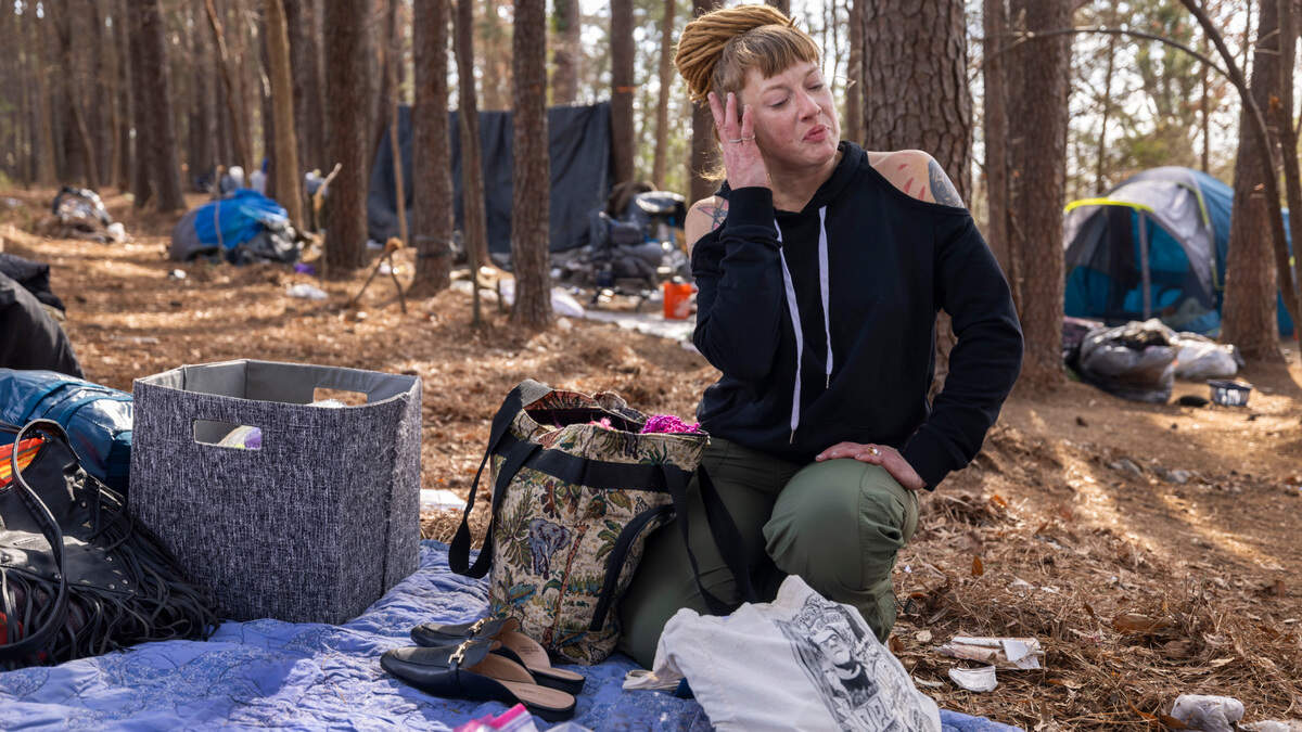 Nicole Reynolds packs up her personal belongings on Friday, January 31, 2025 in an encampment along Goode Street in Raleigh, N.C. Reynolds is among a group of people who have been living on a strip of land between Goode Street and the State Farmers Market. The land was recently posted asking for the property to be vacated by January 31, 2025.