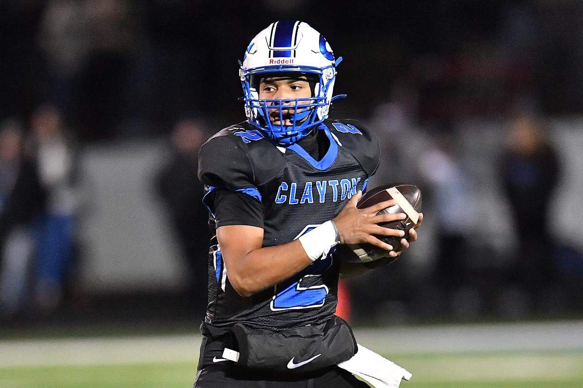 Clayton quarterback Aiden Smalls (2) looks to pass downfield against Southeast Raleigh during the first half. The Clayton Comets and the Southeast Raleigh Bulldogs met in the fourth round of the NCHSAA 7A Playoffs in Clayton, N.C. on November 28, 2025.