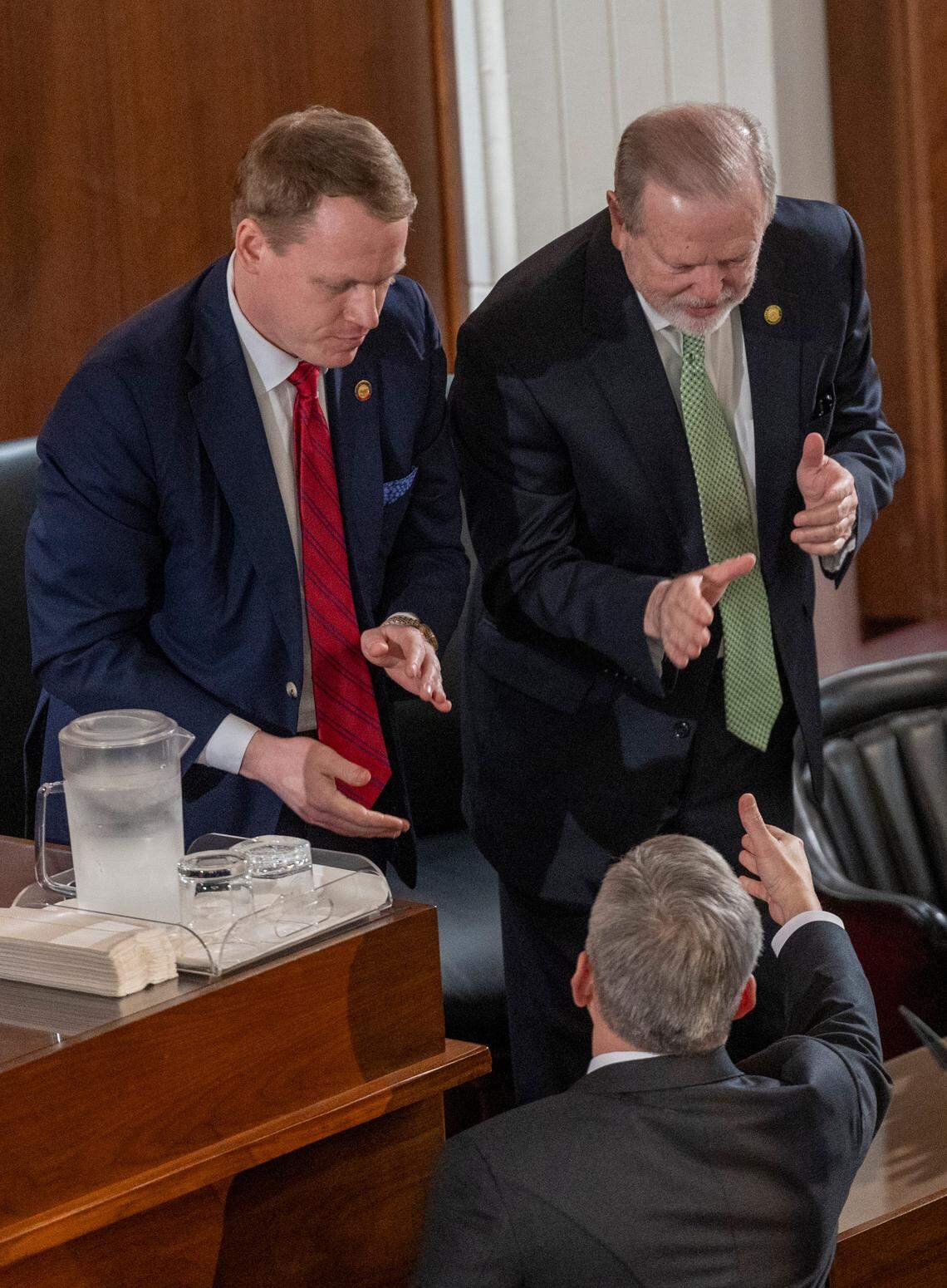 Gov. Josh Stein shakes hands with House Speaker Destin Hall, and Senate leader Phil Berger after delivering his State of the State address to a joint session of the General Assembly on Wednesday, March 12, 2025, in the House chamber of the Legislative Building.