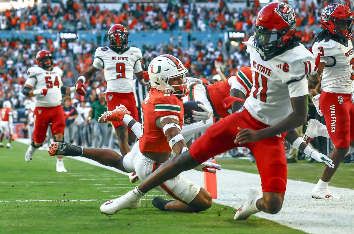 Miami Hurricanes defensive back Jakobe Thomas (8) returns an interception for a touchdown in the first half against the NC State Wolfpack at Hard Rock Stadium in Miami Gardens, Florida, on Saturday, November 15, 2025. 