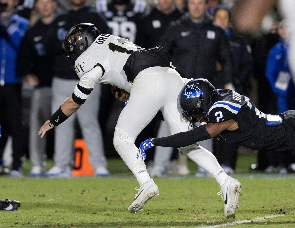 Duke’s Jaylen Stinson tackles Wake Forest quarterback Mitch Griffis during the first half of the Blue Devils’ game on Thursday, Nov. 2, 2023, at Wallace Wade Stadium in Durham, N.C.