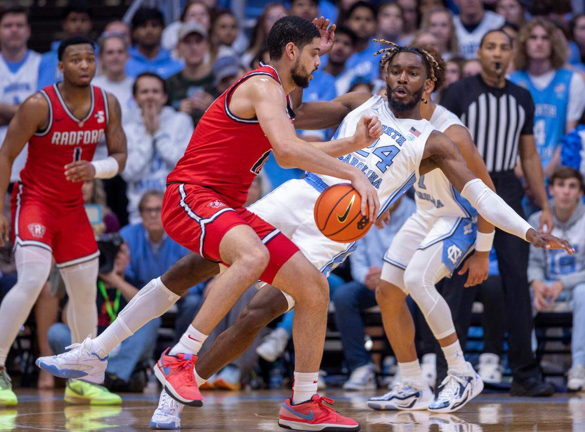 Radford’s Chandler Turner (10) collides with North Carolina’s Jae’Lyn Withers (24) in the first half on Monday, November 6, 2023 at the Dean Smith Center in Chapel Hill, N.C.