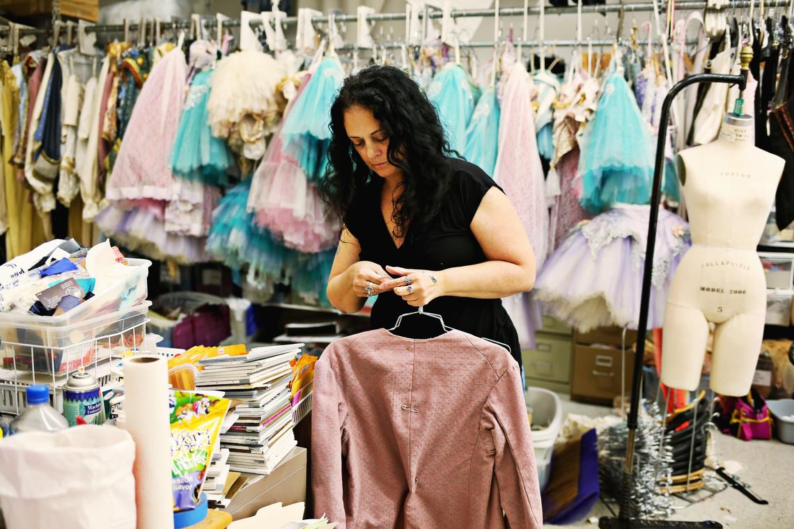 Carolina Ballet first hand, Christine McInnis, looks over costumes in need of alterations for "Sleeping Beauty" on May 7, 2018, in preparation for the last show of the season.