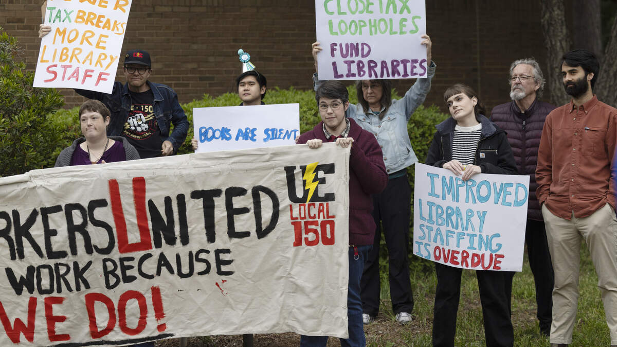 Wake County library workers and supporters demonstrate outside the Wake County Commons Building in Raleigh before a public hearing on the county’s proposed fiscal 2027 budget on Monday, May 11, 2026. Protesters say chronic understaffing and reductions in staff hours are affecting library programming and services.