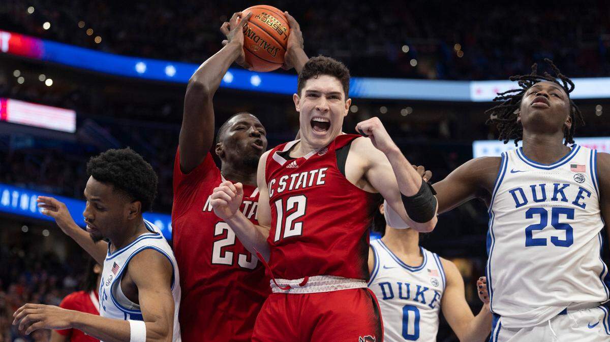 N.C. State’s Mohamed Diarra (23) secures the final defensive rebound as the clock expires, and teammate Michael O’Connell (12) begins the celebration of the Wolfpack’s 74-69 victory over Duke in the quarterfinals of the ACC Men’s Basketball Tournament at Capitol One Arena on Wednesday, March 13, 2024 in Washington, D.C.