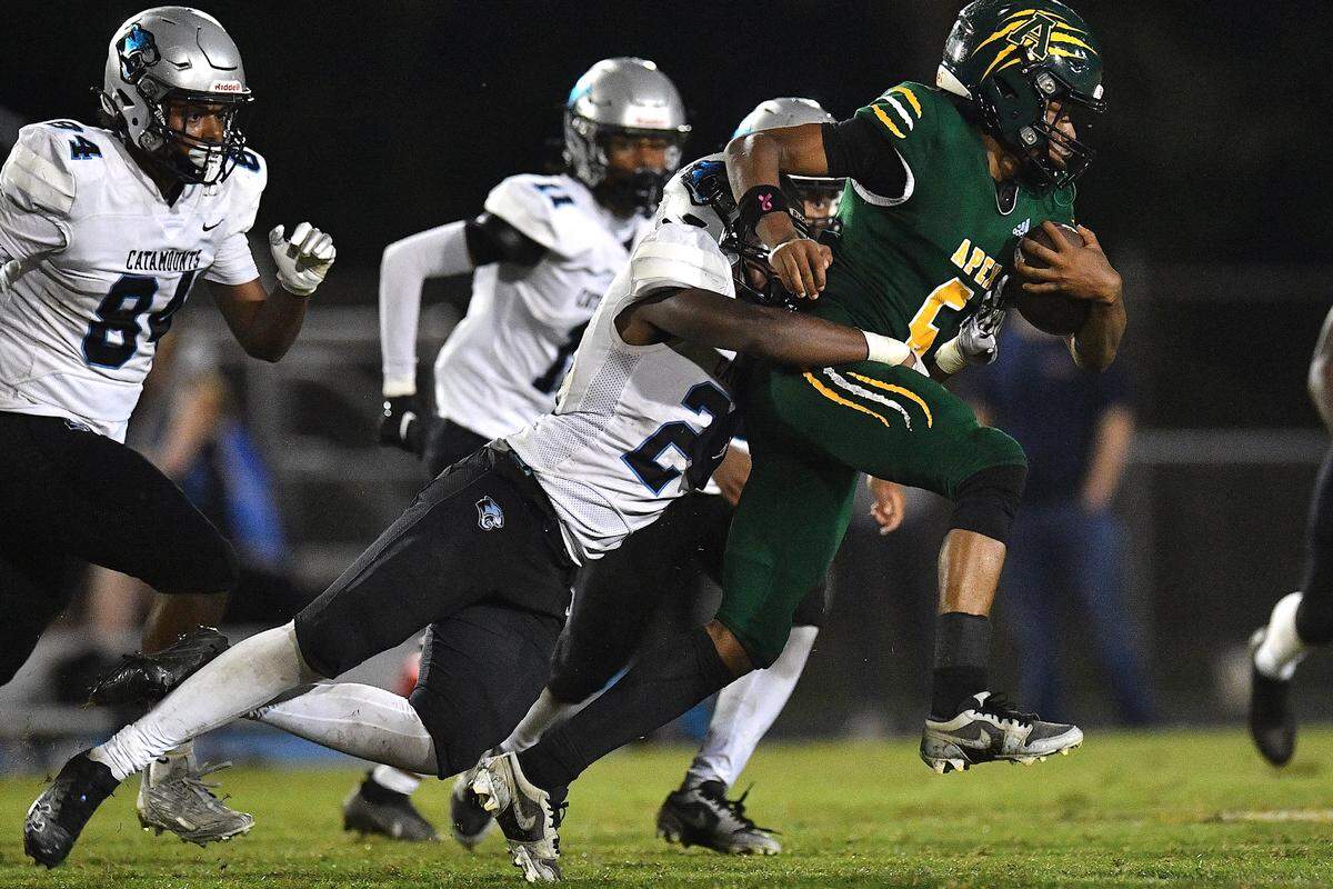 Apex wide receiver Coby Walker (6) runs for the first down against Panther Creek’s Edwin Akpu (24) during the second half. The Apex Cougars and the Panther Creek Catamounts met in a conference football game in Apex, N.C. on September 20, 2024.