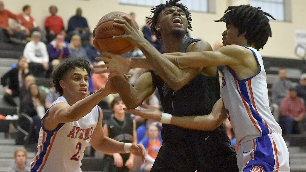Athens Drive’s Chase Graham (2) and Tevon Johnson (3) tie up Green Hope’s Justin Graham (4). The Athens Drive Jaguars and the Green Hope Falcons met in the Tri-6 Conference Finals in Cary, N.C. on February 20, 2019.
