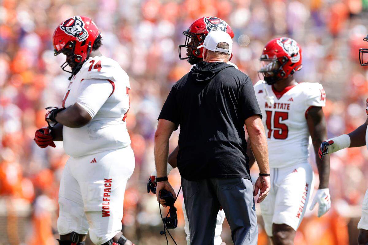 N.C. State head coach Dave Doeren yells at Anthony Belton (74) as he comes off the field after he was called for a penalty during the first half of N.C. State’s game against Clemson at Memorial Stadium in Clemson, S.C., Saturday, Sept. 21, 2024. Belton was ejected from the game.