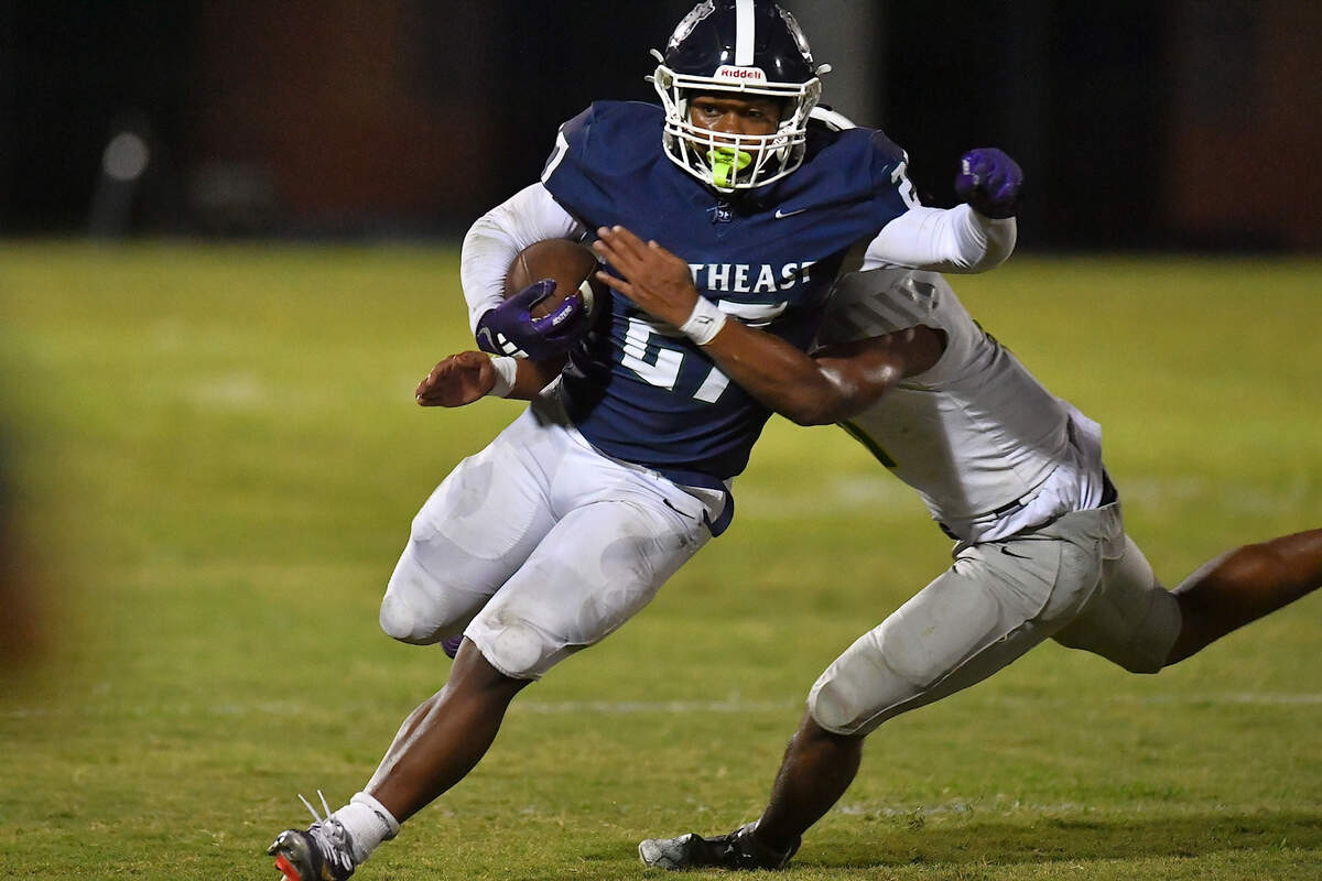 Southeast Raleigh running back James Adams IV (27) runs for yardage and the touchdown against Cardinal Gibbons Truth Caesar (25) during the second half.  The Southeast Raleigh Bulldogs and the Cardinal Gibbons Crusaders met in a non-conference football game in Raleigh, N.C. September 12, 2025
