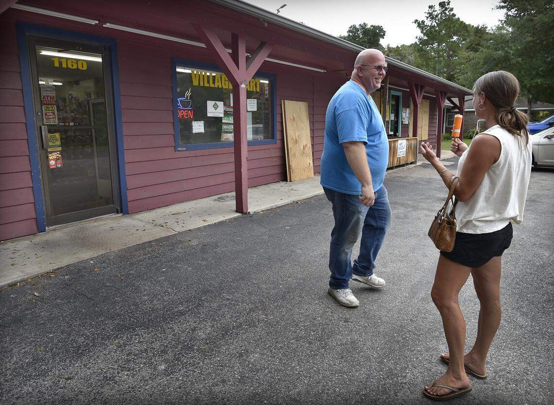 Charles Williams, left, and Meely Pruett share a laugh, and of course talk about the latest forcast for Hurricane Florence Thursday morning after Pruett stopped at the Village Mart on the outskirts of Shallotte. Williams, who owns and operates the business, plans to ride the storm out at the store. ``This is nothing new for us,’’ he said.
