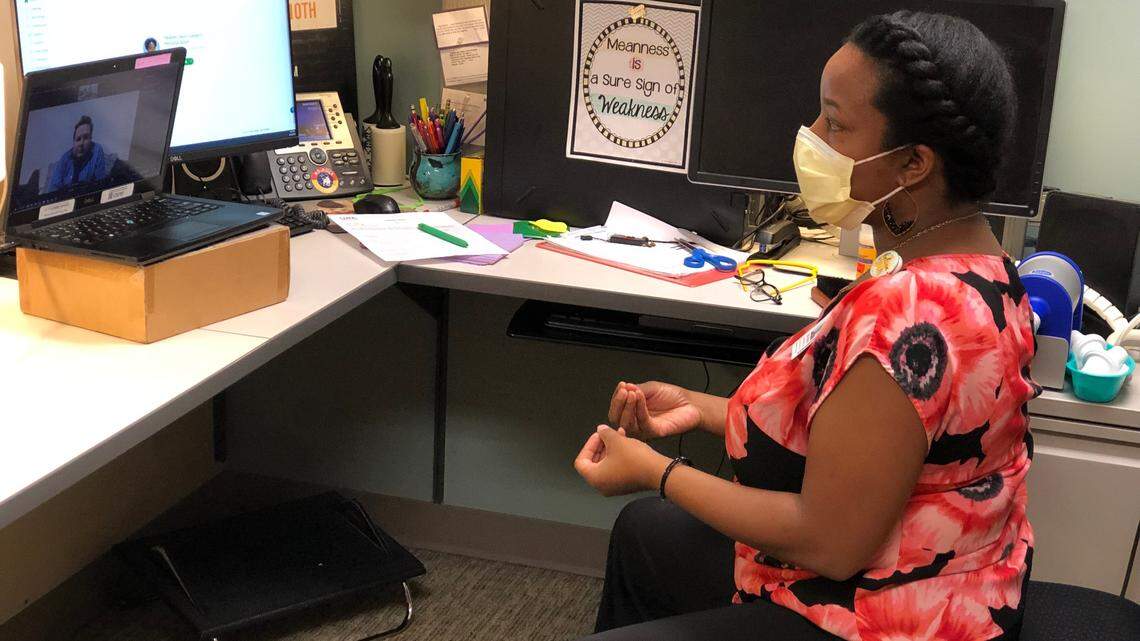 Heather Davis, a voice therapist at UNC, teaches breathing exercises to new patient Alyx Ashby of Newton to help a patient recover from long COVID-19.