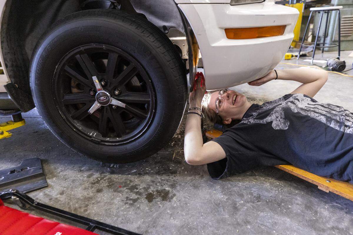 Eleventh-grader Ella Baxter works on her 2006 Ford Mustang during an automotive technology class at East Wake High School in Wendell on Wednesday, May 6, 2026.